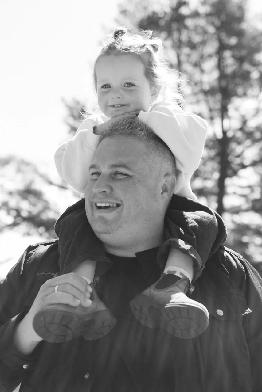 Josh carrying his daughter on his shoulders.