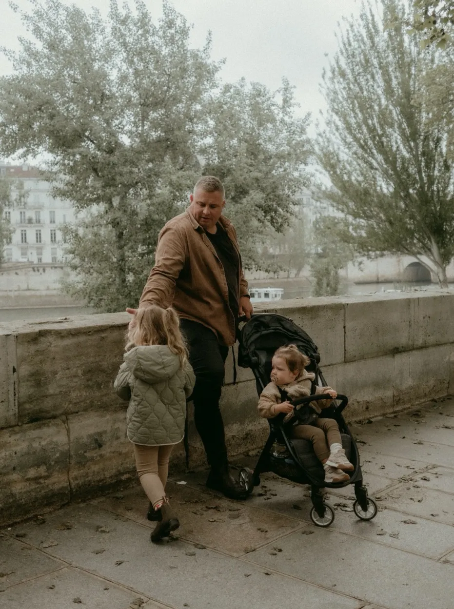 Josh out for a walk with his two daughters beside the river in Paris.